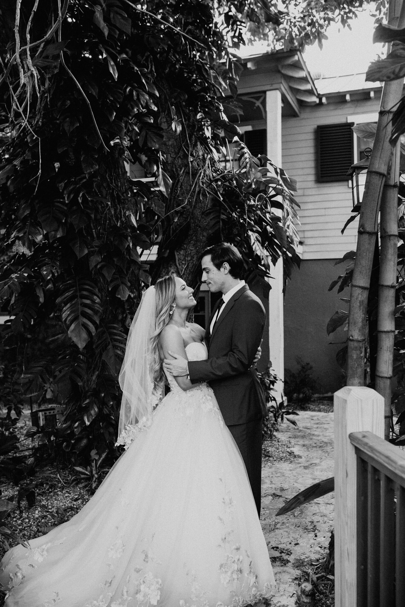 Black-and-white portrait of the newlyweds sharing a quiet embrace