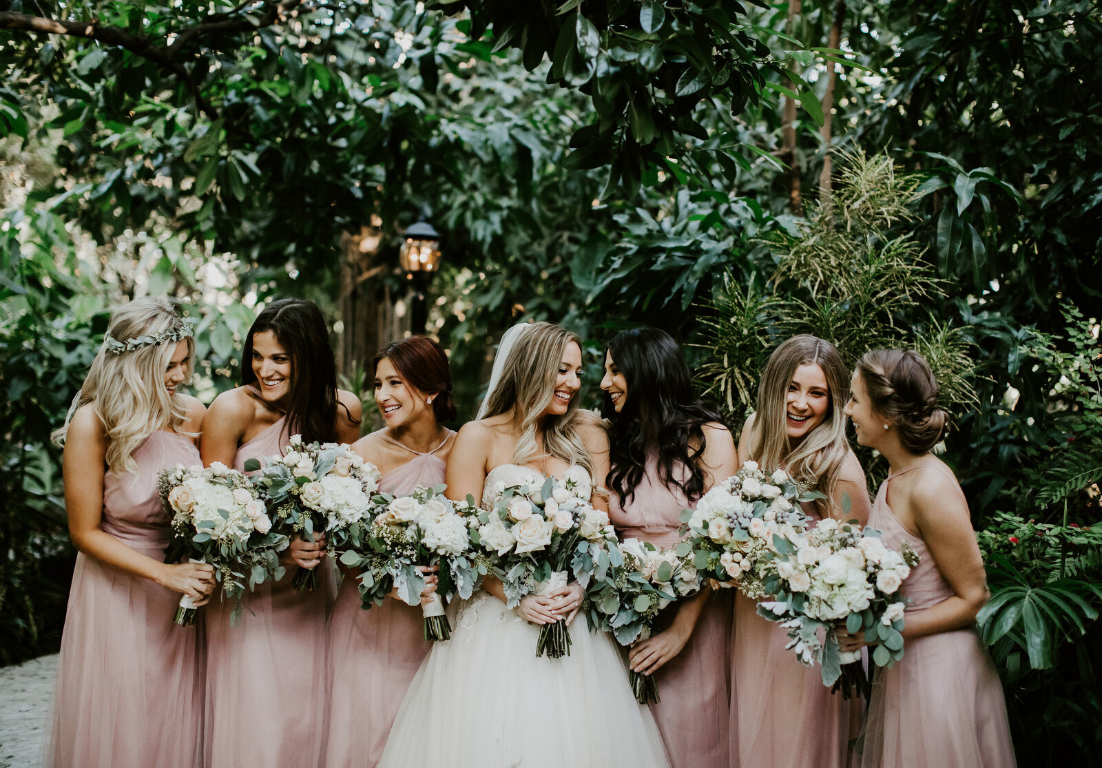 The bride and her bridesmaids sharing a candid laugh